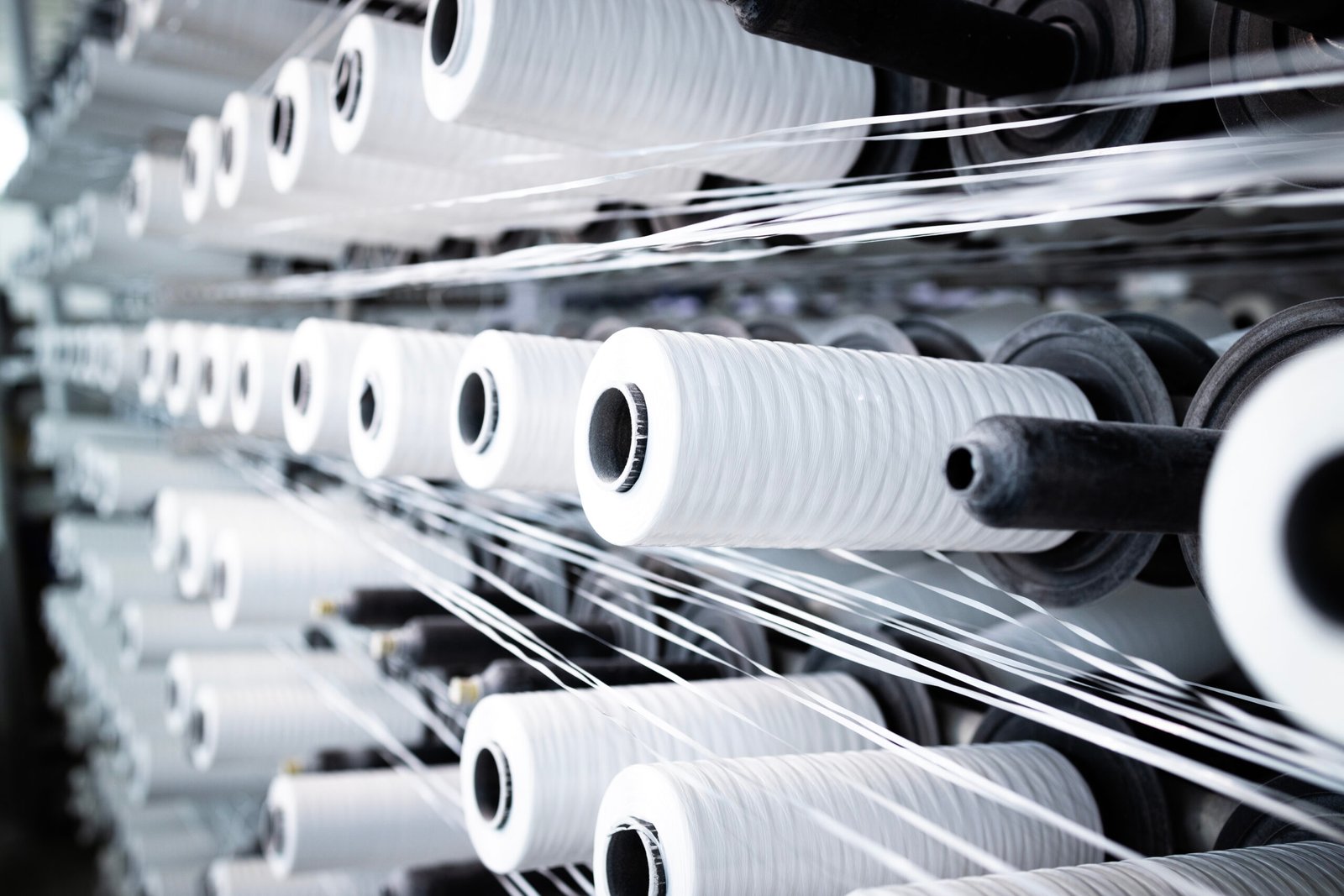 Industrial textile machine with thread spool.